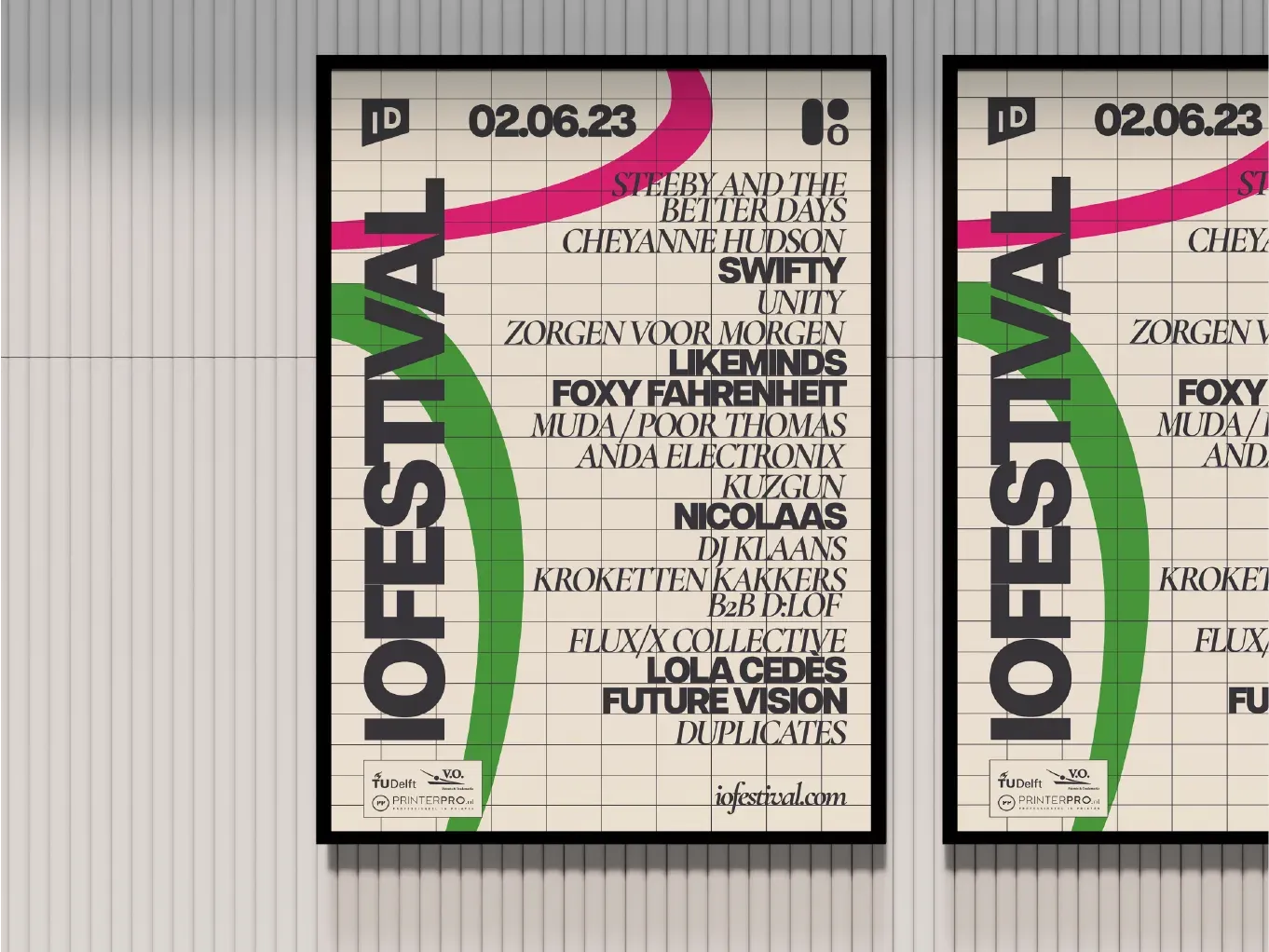 Two framed IO Festival lineup posters on a light grey wall, with a pink and green ribbon running across a grid of artist names.