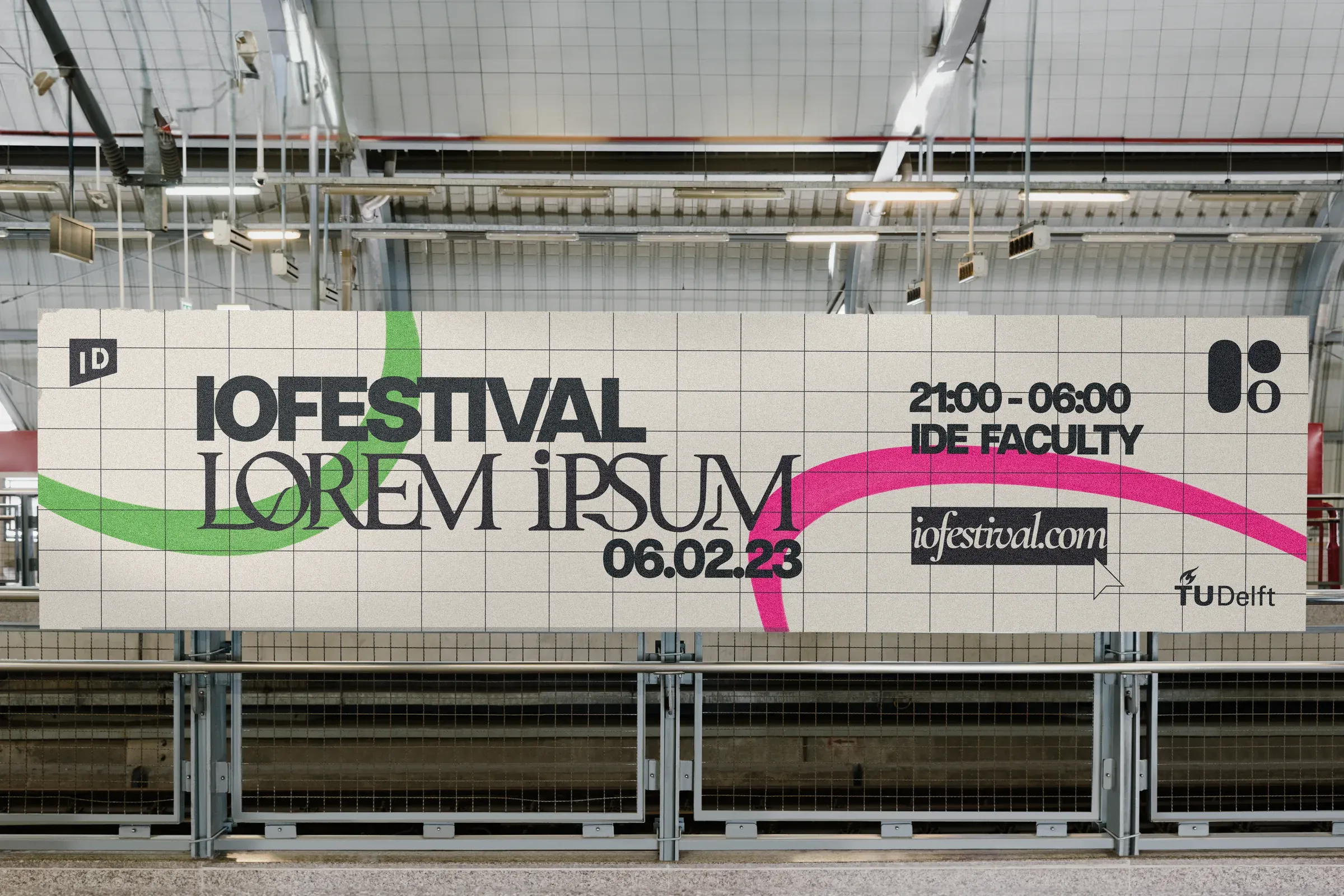 IO Festival banner hanging from a railing in a large industrial hall, with the date and the IDE Faculty as location.