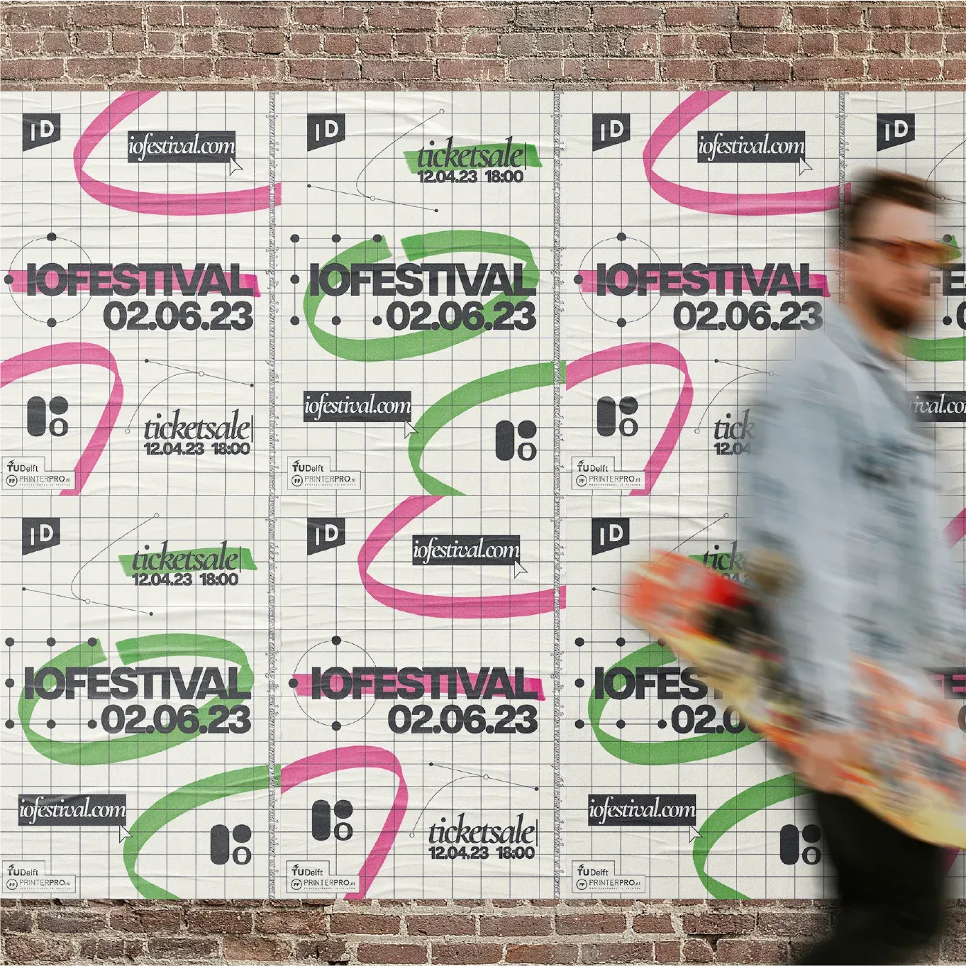 A brick wall covered in repeated IO Festival posters, with a person walking past.